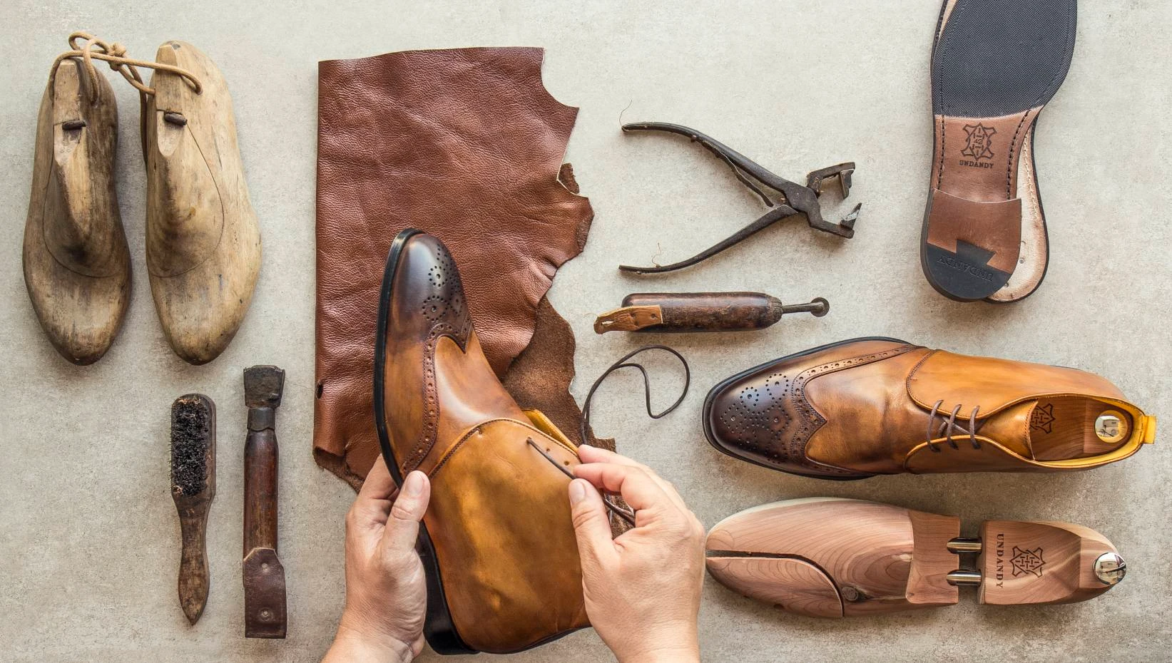 a person sewing a shoe