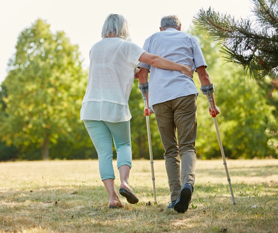 a man and woman walking with crutches