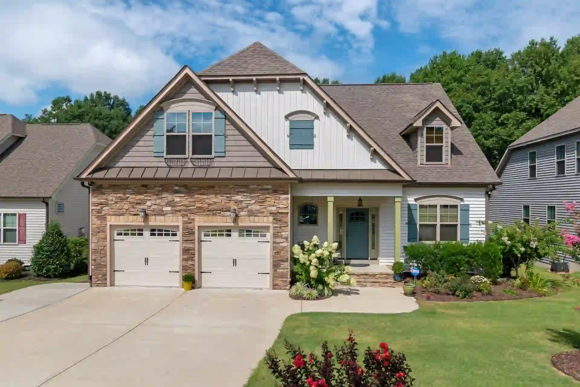 a house with a driveway and a lawn